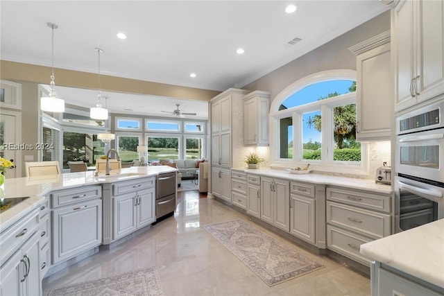 kitchen featuring sink, light tile patterned floors, double oven, decorative backsplash, and decorative light fixtures