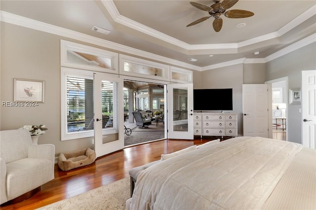 bedroom with french doors, ornamental molding, and a raised ceiling