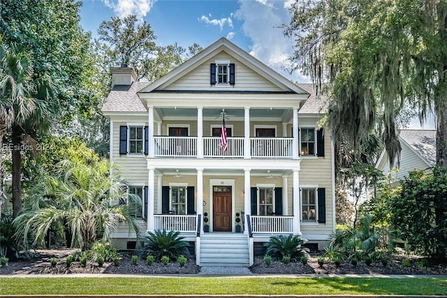 view of front of property featuring a porch and a balcony