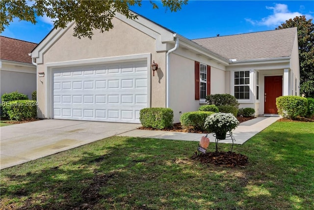 ranch-style home with a garage and a front yard