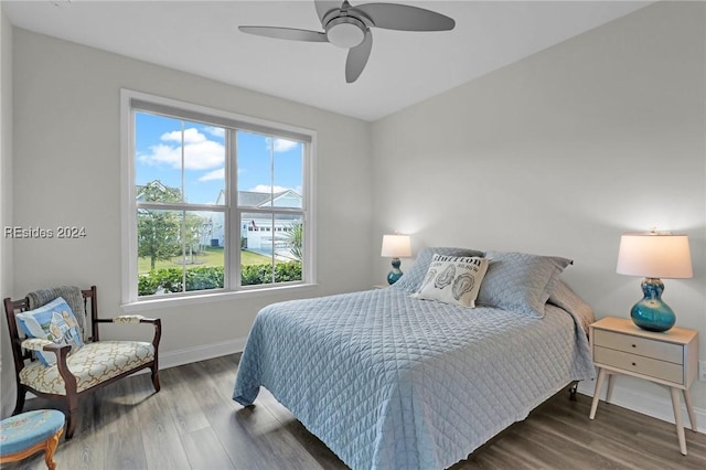 bedroom with ceiling fan and dark hardwood / wood-style flooring