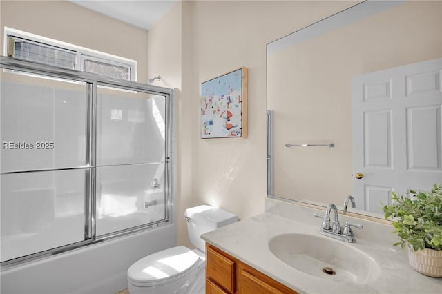 full bathroom with toilet, vanity, and shower / bath combination with glass door