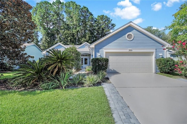 single story home featuring a garage and a front yard