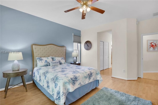 bedroom with ceiling fan, hardwood / wood-style floors, and a closet