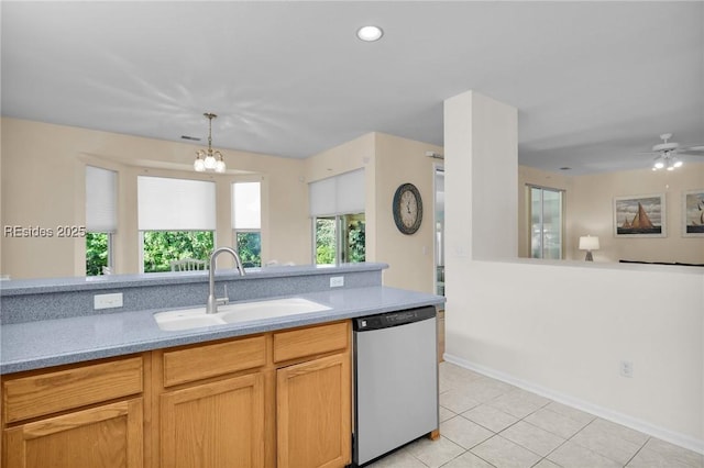 kitchen featuring light tile patterned flooring, pendant lighting, dishwasher, sink, and a chandelier