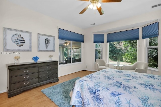 bedroom with ceiling fan and light hardwood / wood-style flooring