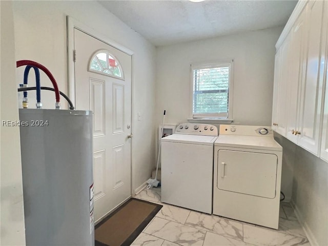 laundry area featuring separate washer and dryer, cabinets, and water heater