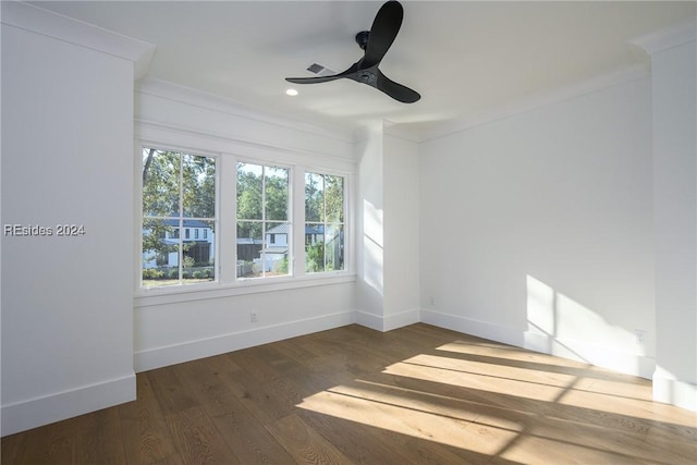 empty room with dark wood-type flooring, ceiling fan, and ornamental molding