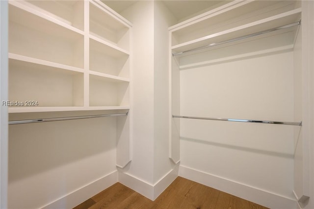 spacious closet featuring hardwood / wood-style flooring