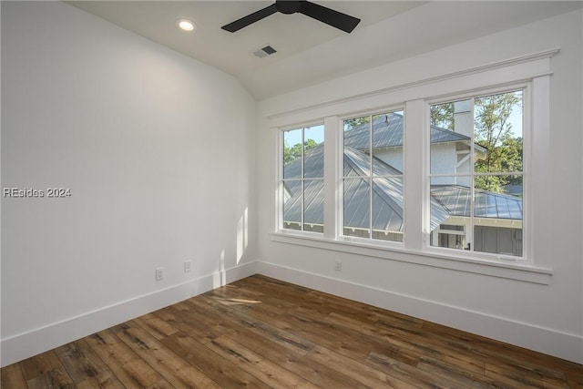 empty room featuring ceiling fan, dark hardwood / wood-style floors, and vaulted ceiling