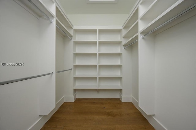 walk in closet featuring dark hardwood / wood-style flooring