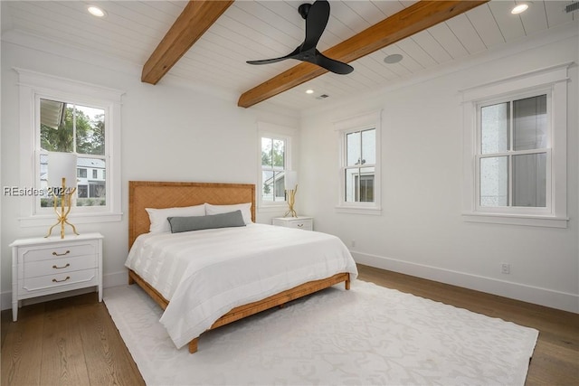 bedroom featuring ceiling fan, dark hardwood / wood-style flooring, wood ceiling, and beam ceiling