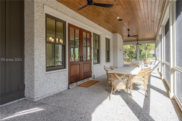 sunroom with ceiling fan and wooden ceiling