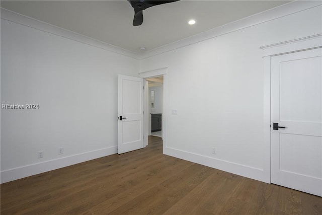 spare room featuring dark hardwood / wood-style flooring and ornamental molding