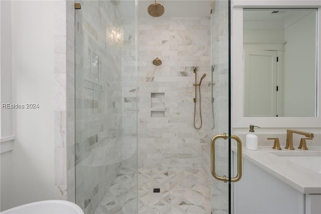 bathroom with vanity and a shower with shower door