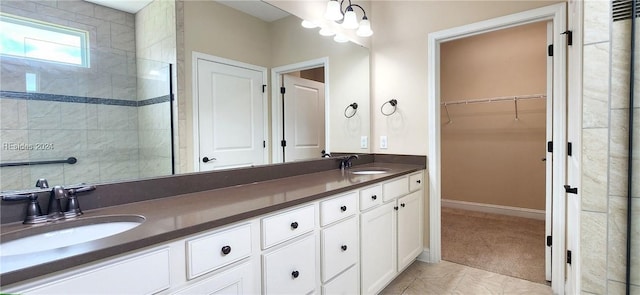 bathroom featuring walk in shower, vanity, tile patterned flooring, and a notable chandelier