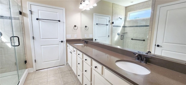 bathroom featuring vanity, a shower with door, and tile patterned floors