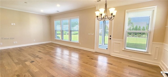 interior space with ornamental molding, a chandelier, and light wood-type flooring