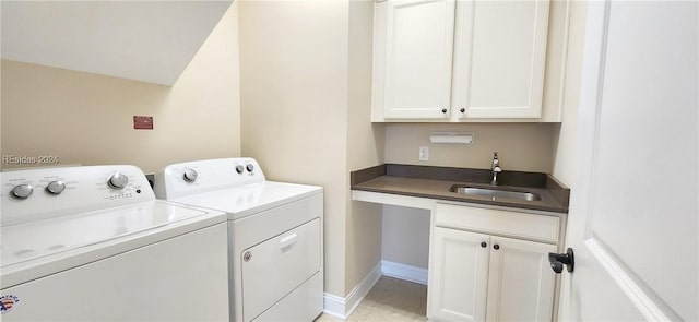 laundry room featuring cabinets, sink, and washer and dryer