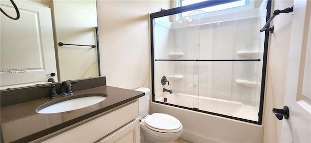 full bathroom with toilet, vanity, and shower / bath combination with glass door