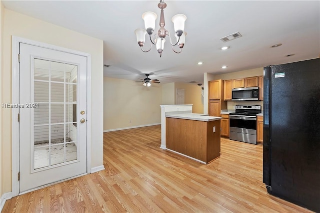 kitchen with ceiling fan with notable chandelier, decorative light fixtures, a center island, stainless steel appliances, and light hardwood / wood-style flooring