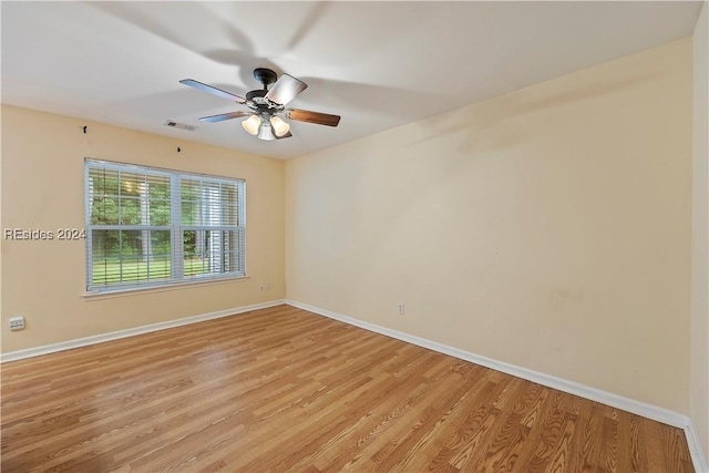 spare room with ceiling fan and light hardwood / wood-style flooring