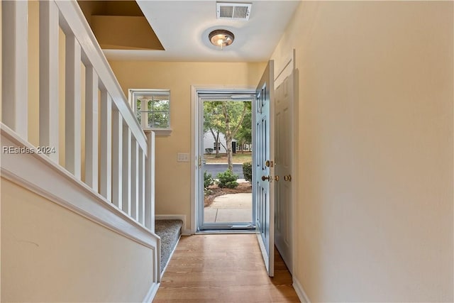 foyer entrance with light hardwood / wood-style floors