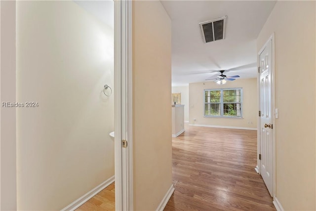 hallway with light hardwood / wood-style flooring