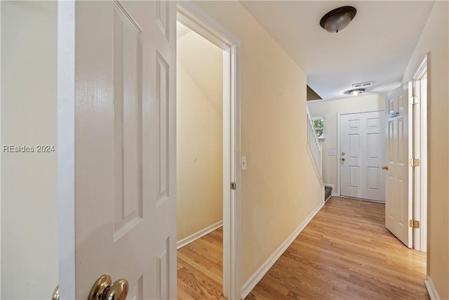 corridor with light hardwood / wood-style flooring