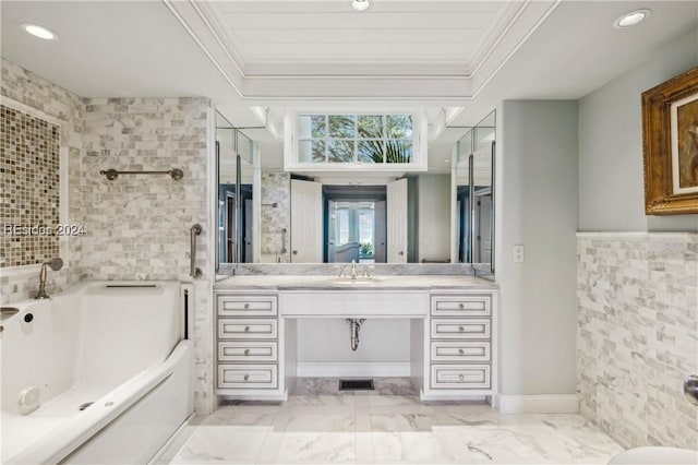 bathroom featuring vanity, ornamental molding, and a bathing tub