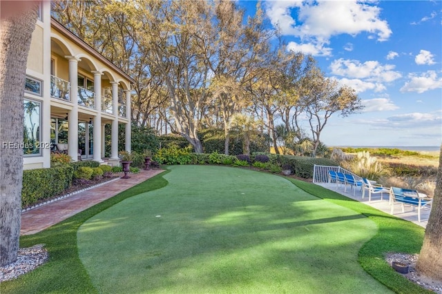 view of yard with a balcony and a patio