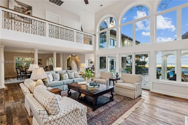 sunroom featuring ceiling fan and ornate columns