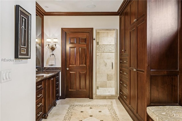 bathroom with ornamental molding, a shower with shower door, and vanity