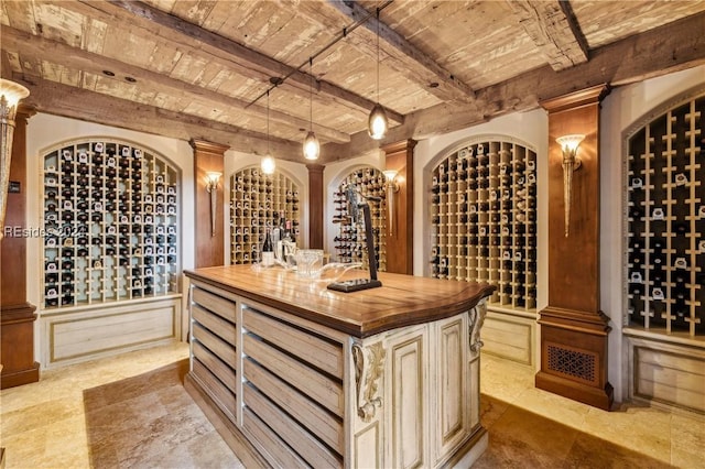 wine room featuring wood ceiling and beam ceiling