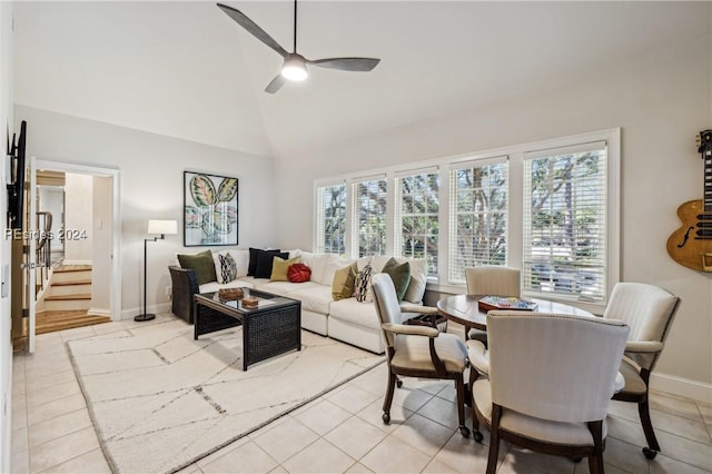 tiled living room with lofted ceiling and ceiling fan