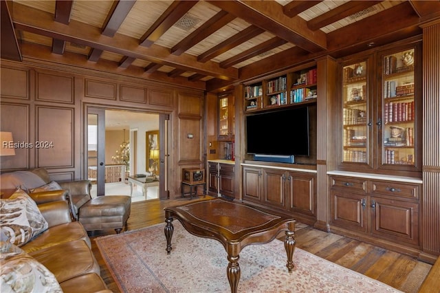 living room featuring wood ceiling, wooden walls, hardwood / wood-style floors, and beam ceiling