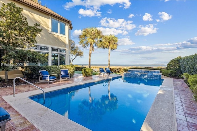 view of swimming pool featuring an in ground hot tub and a patio