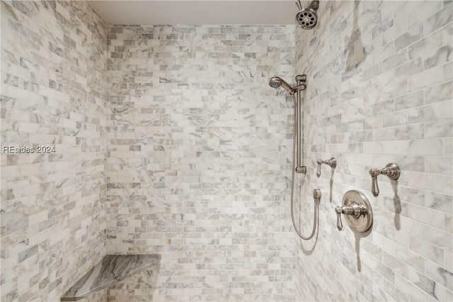 bathroom with a tile shower