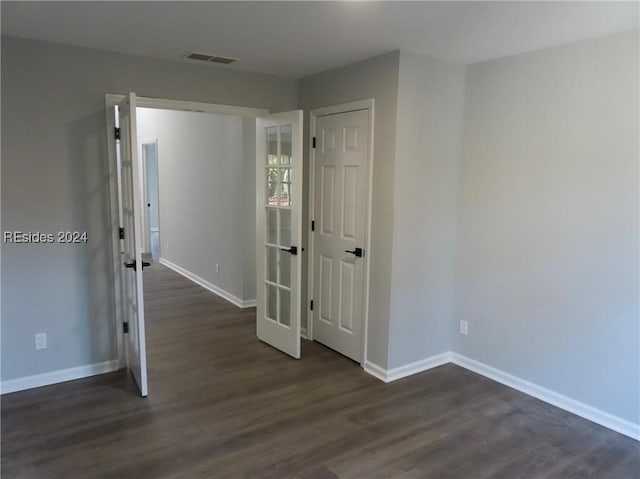 spare room with dark wood-type flooring