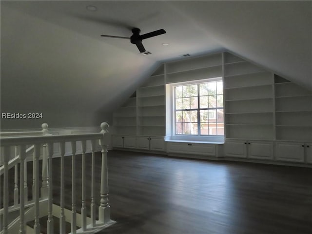 bonus room with vaulted ceiling, ceiling fan, built in features, and dark hardwood / wood-style flooring