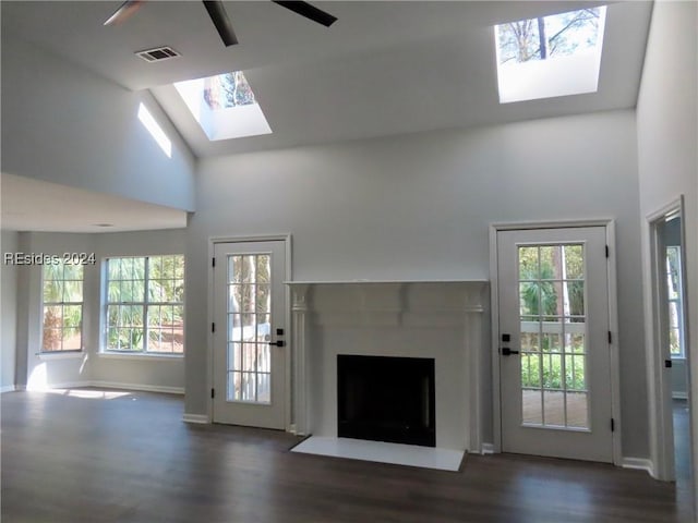 unfurnished living room with dark hardwood / wood-style flooring and high vaulted ceiling