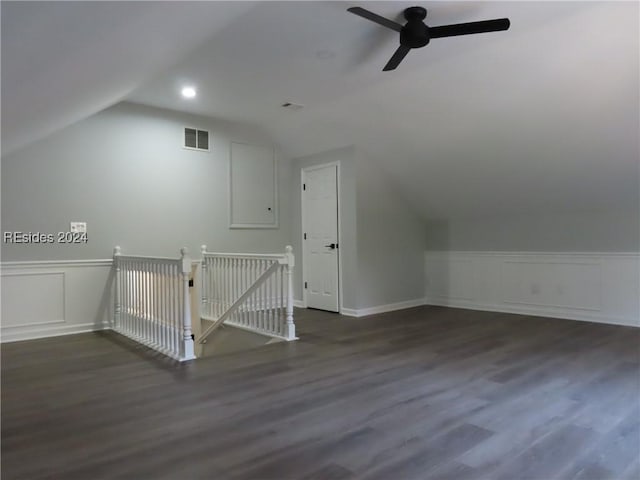 additional living space with lofted ceiling, dark wood-type flooring, and ceiling fan