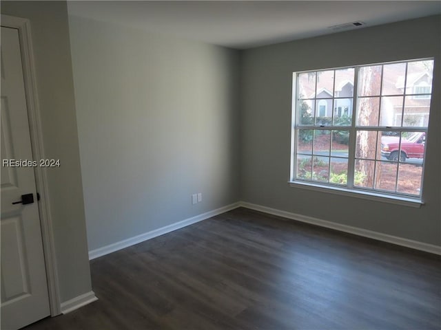 spare room with dark hardwood / wood-style flooring