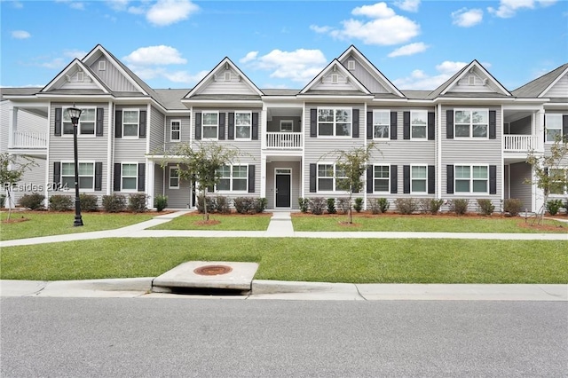 multi unit property featuring an outdoor fire pit and a front lawn