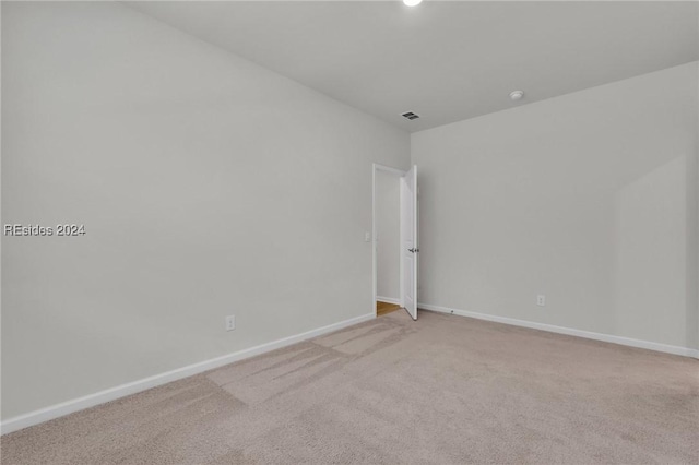 unfurnished room with light colored carpet