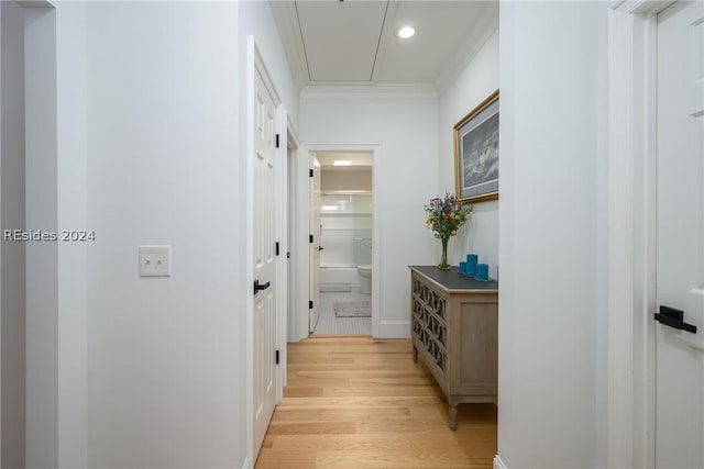 hall with crown molding and light wood-type flooring