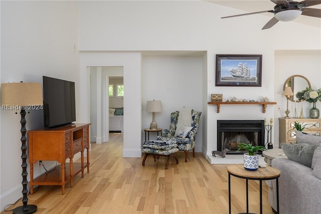 living room featuring ceiling fan and light hardwood / wood-style flooring