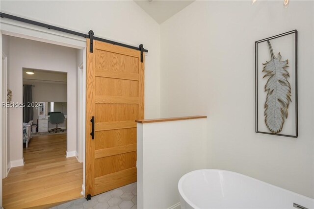 bathroom featuring a washtub, hardwood / wood-style floors, and lofted ceiling