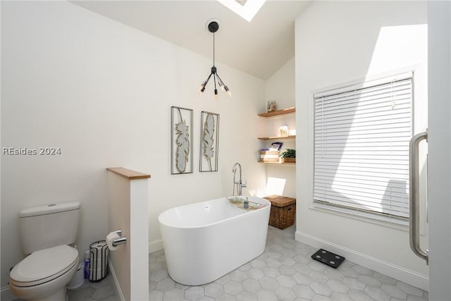 bathroom with tile patterned flooring, lofted ceiling, a bath, and toilet