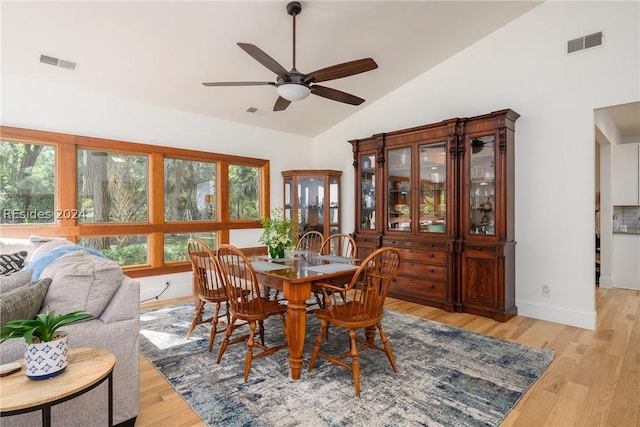 dining room featuring lofted ceiling, light hardwood / wood-style floors, and ceiling fan